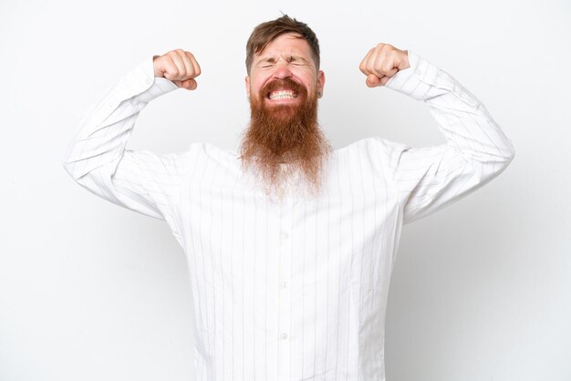 Redhead man with long beard isolated on white background doing strong gesture