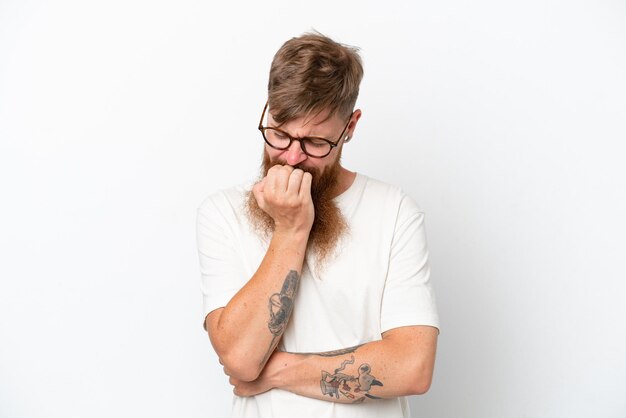 Redhead man with long beard isolated on white background having doubts