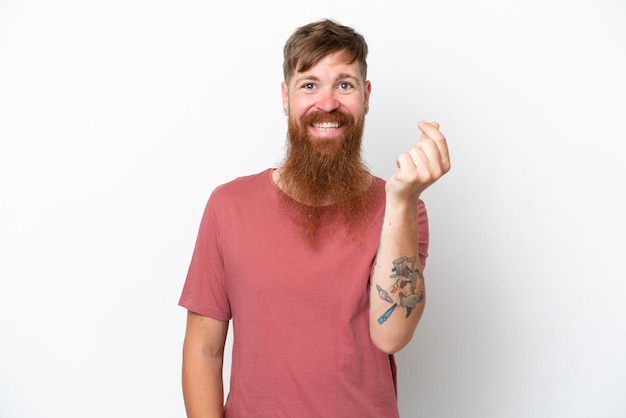 Redhead man with long beard isolated on white background making money gesture