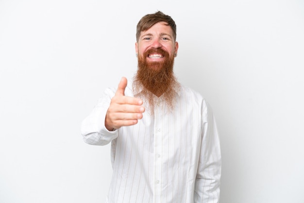 Redhead man with long beard isolated on white background shaking hands for closing a good deal