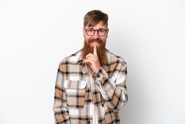 Redhead man with long beard isolated on white background showing a sign of silence gesture putting finger in mouth