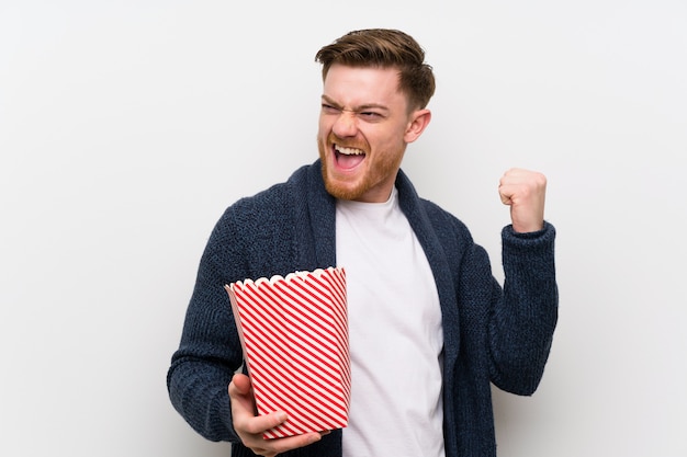 Redhead man with popcorns