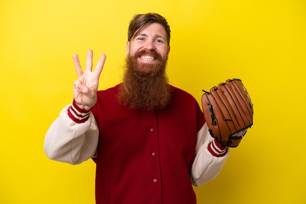 黄色の背景幸せと指で 3 つを数える上で分離されて野球グローブとひげを持つ赤毛プレーヤー男