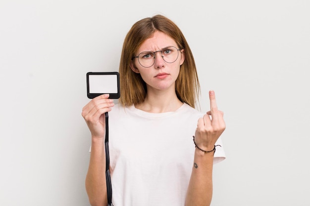 Redhead pretty girl feeling angry annoyed rebellious and aggressive vip pass id concept