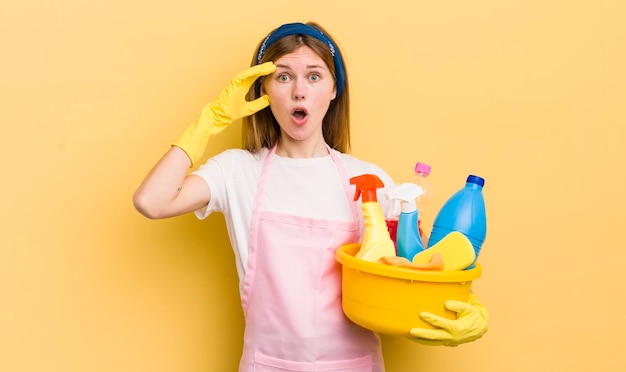 Redhead pretty girl looking happy astonished and surprised housekeeper concept