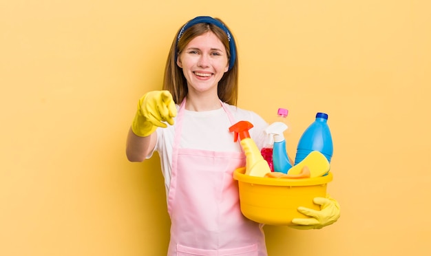 Redhead pretty girl pointing at camera choosing you housekeeper concept