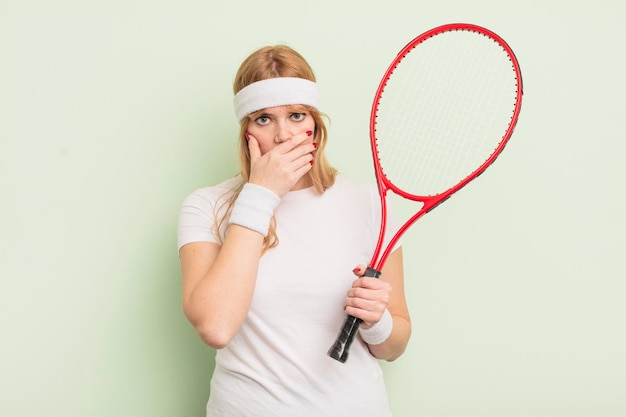 redhead pretty woman covering mouth with hands with a shocked. tennis concept