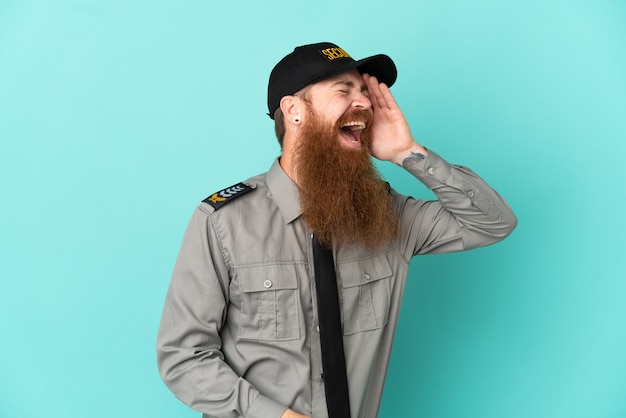 Redhead security man isolated on white background has realized something and intending the solution