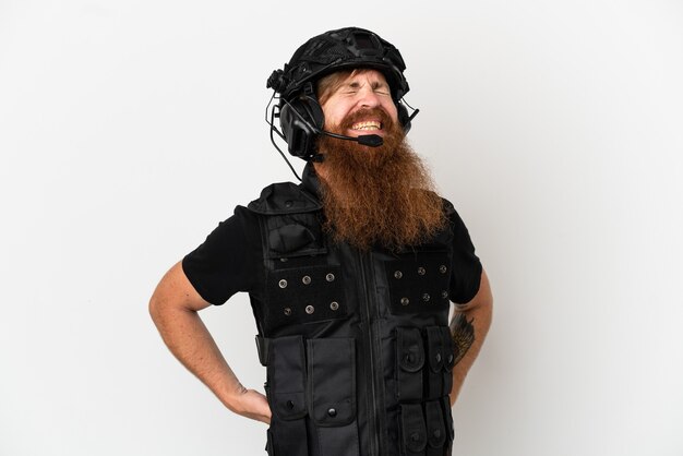 Redhead SWAT isolated on white background suffering from backache for having made an effort