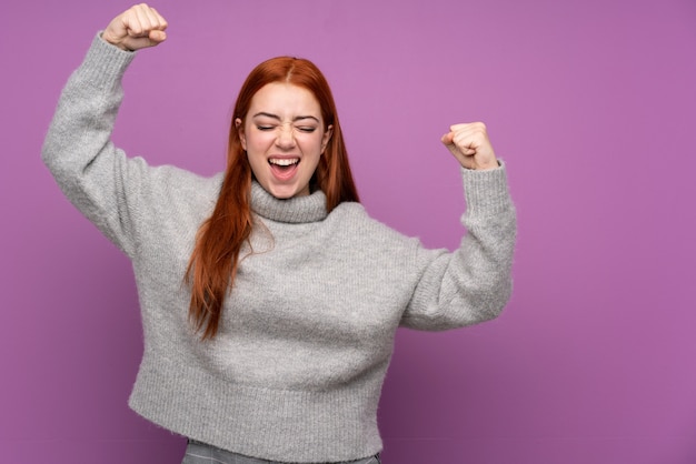 Redhead teenager woman celebrating a victory