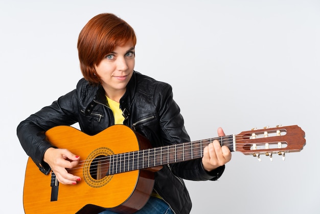 Redhead woman playing guitar