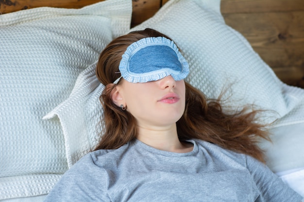 Redhead woman sleeping in bed