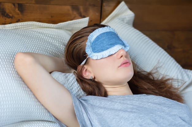 Redhead woman sleeping in bed