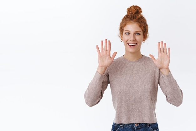 redhead woman with curly hair in blouse, raising hands