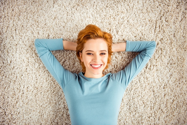 Redhead woman with short hair posing indoors in the living room