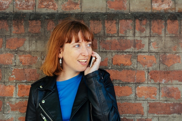 Redhead woman woman talking on her mobile phone.