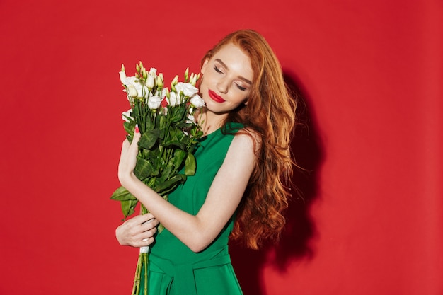 Redhead young shocked girl in green dress