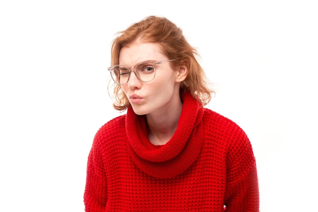 Redhead young woman wearing glasses squinting while looking at camera isolated on white background Vision problems concept