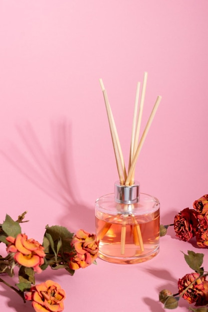 Reed diffuser with flowers Incense sticks for the home with a floral scent with hard shadows The concept of ecofriendly fragrance for the home