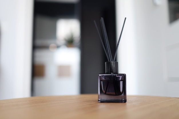 Reed freshener on table in light room, closeup