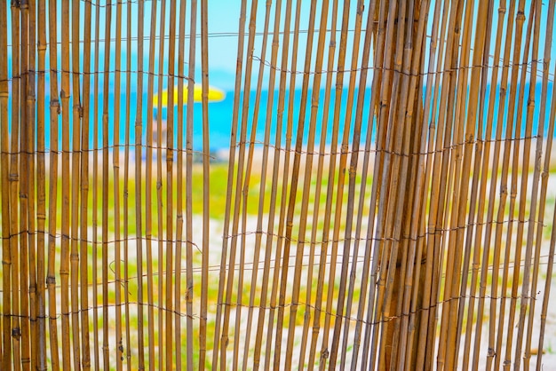 Reeds fence at beach entrance in Alghero Italy