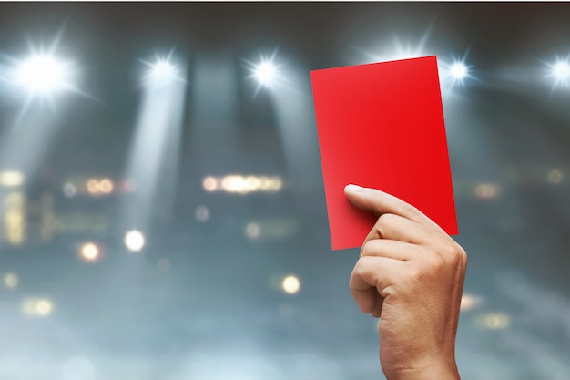 Referee hands showing red card 