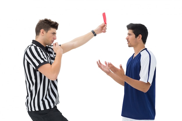 Referee showing red card to football player