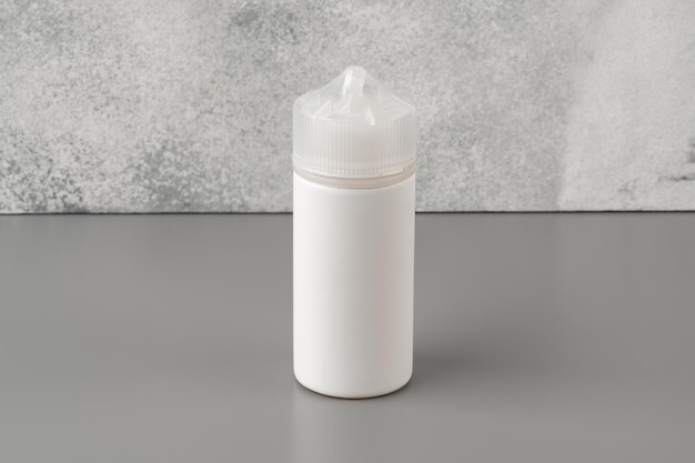 Refill liquid for electronic cigarettes on gray background