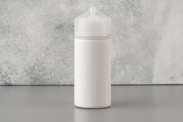 Refill liquid for electronic cigarettes on gray background