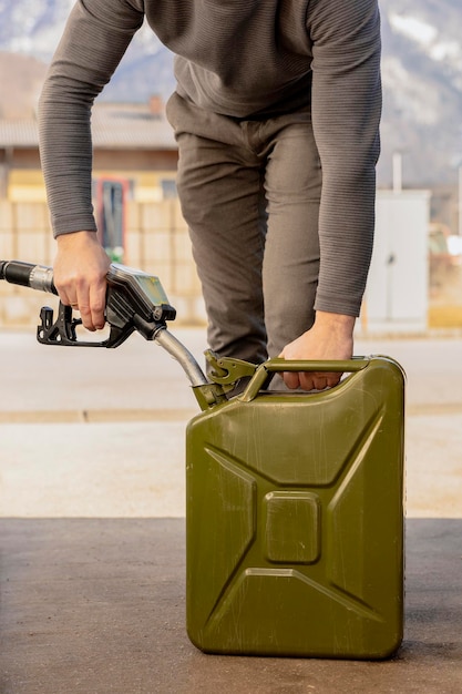 Photo refilling canister with fuel on the petrol station close up view fuel gasoline diesel