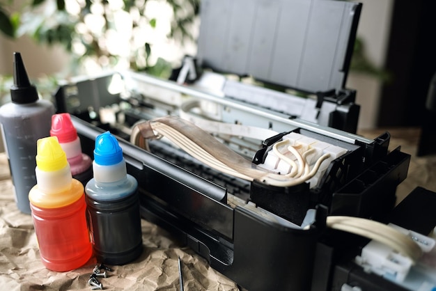 Refilling printer cartridges with multicolored ink Background