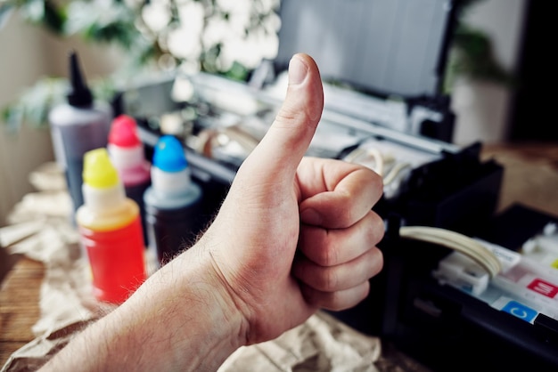 Refilling printer cartridges with multicolored ink Background