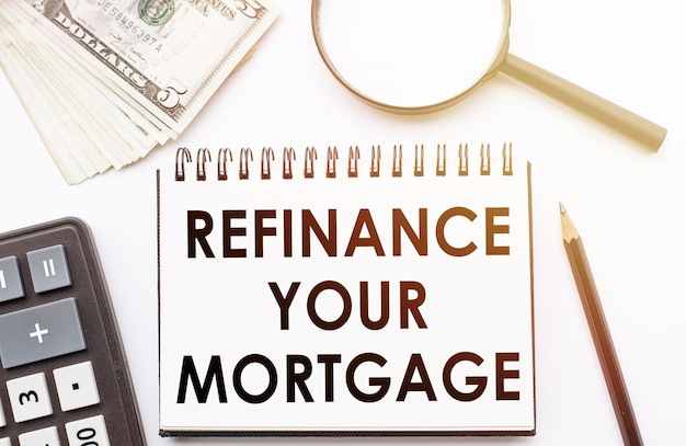 Photo refinance your mortgage text written on a notebook with office background