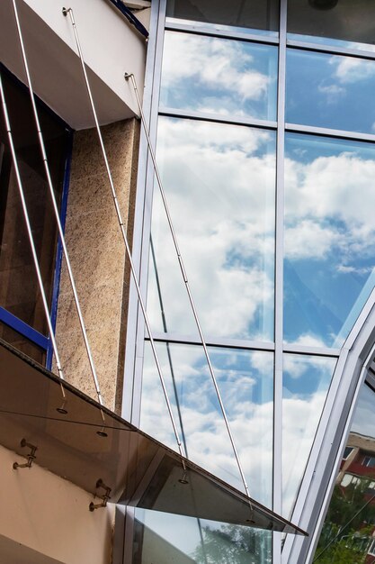 Reflecting clouds in mirrored windows of building