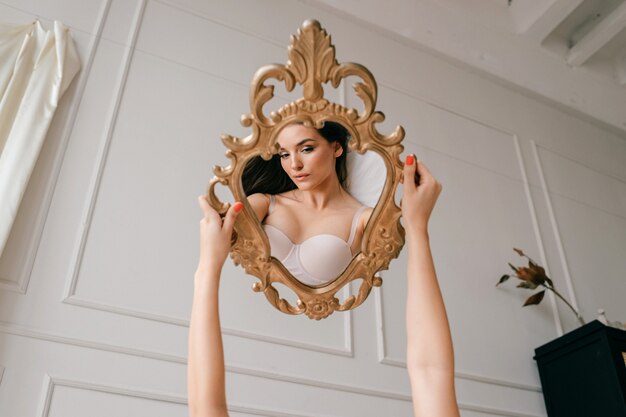 Reflection of beautiful girl portrait holding mirror