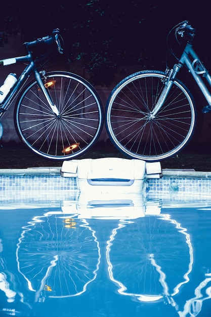 Reflection of bicycles on swimming pool