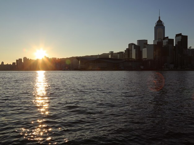 Reflection of buildings in calm water at sunset