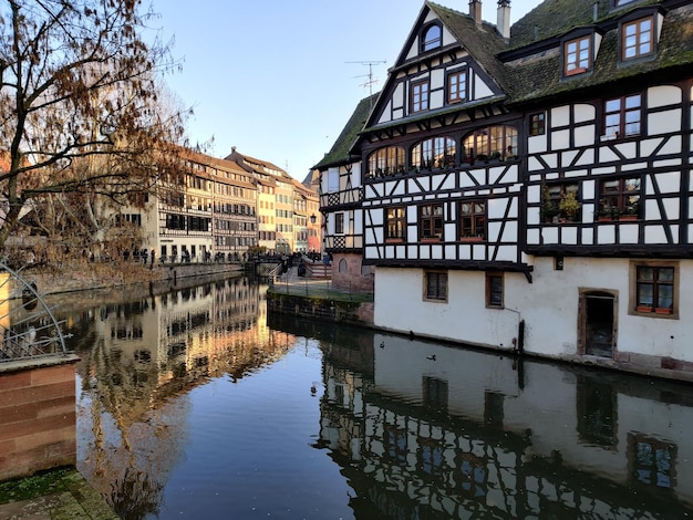 reflection of buildings on canal in city