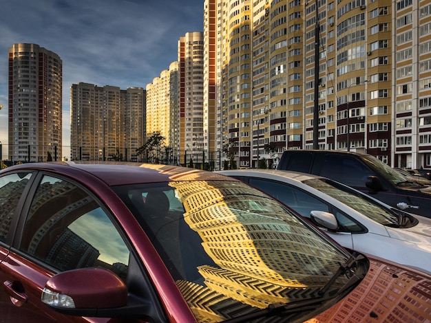 Photo reflection of buildings on car in city