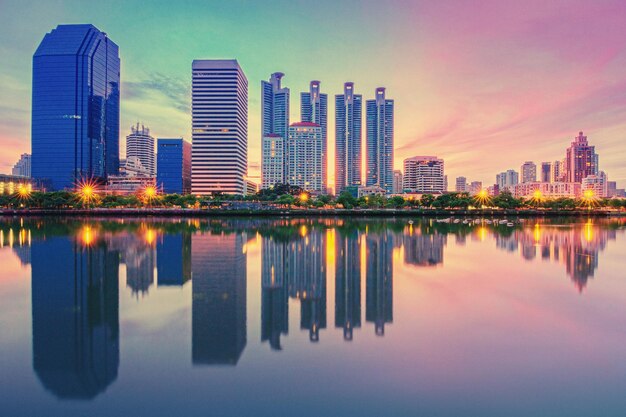 Reflection of buildings in city against sky