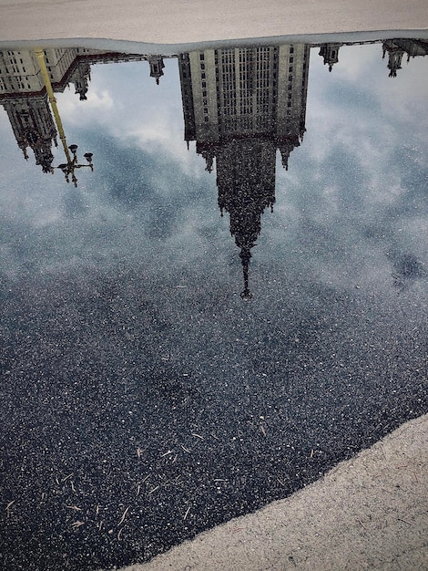 Photo reflection of buildings in puddle