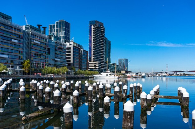 Reflection of buildings in river against blue sky