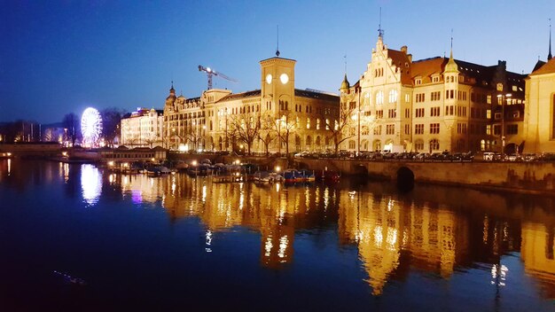 Reflection of buildings in water at night