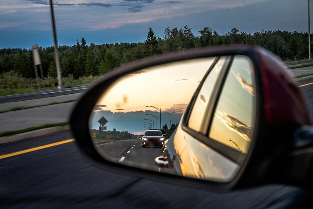 Photo reflection of car on side-view mirror