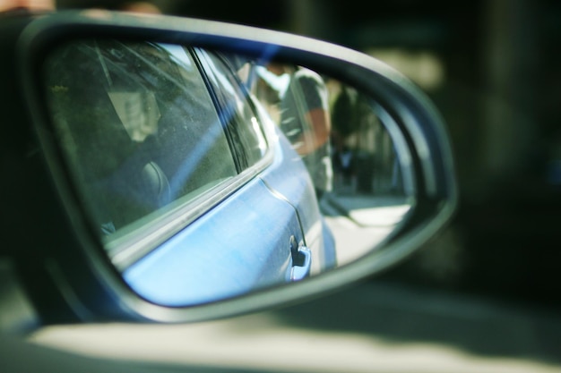 Photo reflection of car on side-view mirror