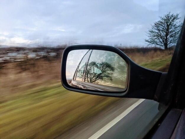 Photo reflection of car on side-view mirror