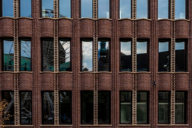 Reflection of the city in the glass of a historic industrial building.