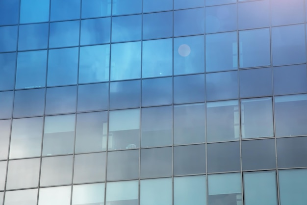 Reflection of clouds in mirrored windows of building