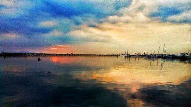 Reflection of clouds in sea at sunset