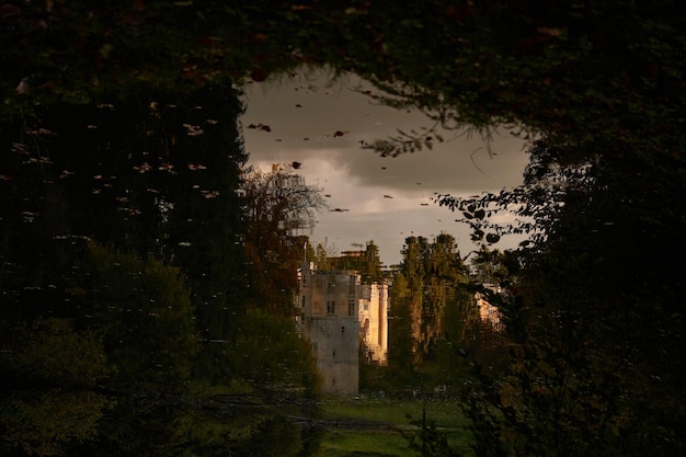 The reflection of eerie Beaufort castle of Luxembourg in the lake